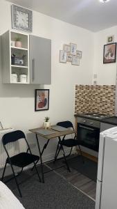 a kitchen with a table and two chairs in a room at BVapartments-Blackhouse F2 in Huddersfield