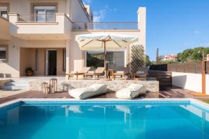 a villa with a swimming pool and a house at Chrissiida Villa in Ialyssos