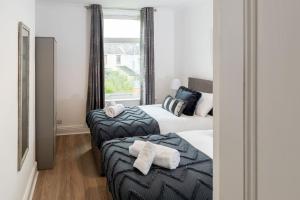 a bedroom with two beds and a window at House of Vacation in Portsmouth