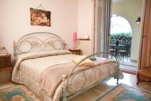 a bedroom with a bed and a balcony with a table at Villa Cecilia Bed and Breakfast in Cellole