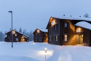 a group of houses in the snow with a candle in the yard at Ranua Resort Holiday Villas in Ranua +36 photos
