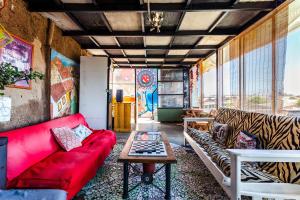 a living room with a red couch and a table at Aji Verde Hostel in La Serena