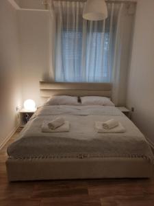 a bedroom with a bed with two towels on it at Apartman 57 in Vračar (historical)