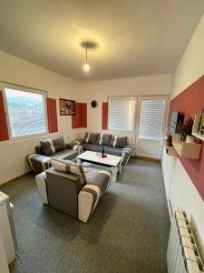 a living room with couches and a table at Apartman Start in Pale +6 photos