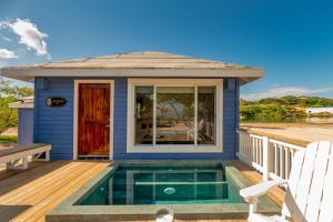 una casa con piscina en una terraza en Barefoot Cay Resort, en Roatan