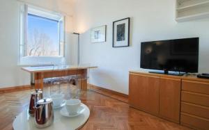 A television and/or entertainment centre at Conca Del Naviglio by Halldis