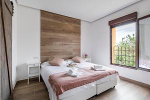 a bedroom with a large bed and a window at Casa Rural de Ancos, Guadamur, Toledo in Guadamur