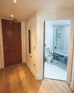 an empty bathroom with a toilet and a shower at Modern, stylish Apt 1 min from New St Station in Birmingham