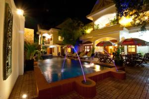 a house with a swimming pool at night at Villa Grange in Phnom Penh