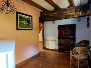 a living room with wooden floors and a wooden door at Saskarate in Asteasu