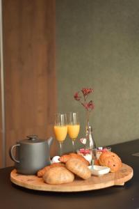 a table with a tray of bread and glasses of wine at Boukje har Bêd en Brochje in Burgum +9 photos