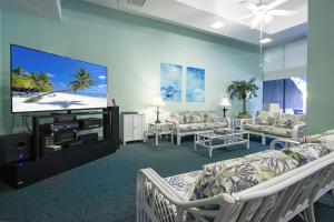 a living room with couches and a flat screen tv at Harbor Tower Intracoastal Condo in Siesta Key