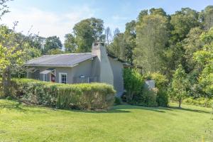 a small white house with a yard at Oakhurst Farm Cottages in Wilderness