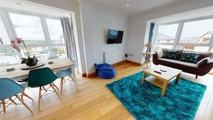a living room with a table and a couch at Cosy Town House Sleeps 8 in Pembroke Dock
