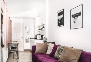 a living room with a purple couch and a table at Alandala by The Center in Cluj-Napoca