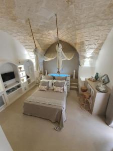 a bedroom with a bed and a stone ceiling at Eurydice Suite with Infinity Jacuzzi in Ostuni