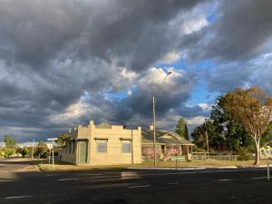 a house on a street with a cloudy sky at Deepwater Bank BnB in Deepwater