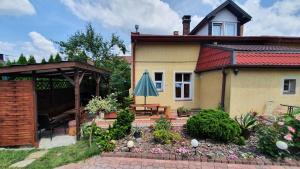 a house with a patio and an umbrella at Brama Bieszczad in Lesko