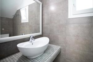 a bathroom with a sink and a mirror at Evas House in Fira