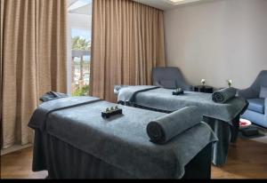 a hospital room with two beds and a couch at Apartment the address resort- Two-Bedroom and maid room in Al Aqah