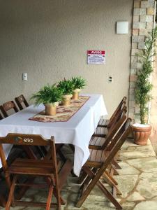 a table with chairs and potted plants on it at casa centro historico 5 quartos in Pirenópolis