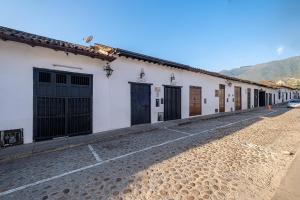 a row of doors on a white building at Ayenda Boutique Macaregua Girón in Girón