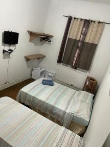 Tempat tidur dalam kamar di Pousada Vila Pitanga