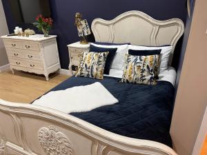 a bed with a blue comforter and pillows at 1-Bed studio Apartment nr Cockermouth in Cockermouth
