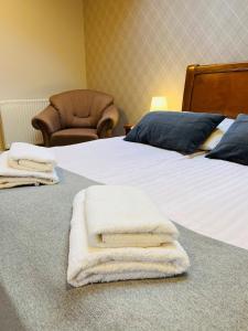 a hotel room with two beds with towels on them at Ośrodek Agroturystyczny Zacisze in Giewartów