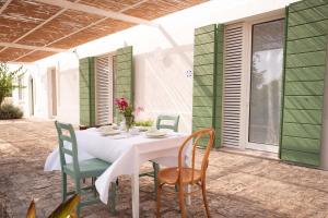 a white table and chairs on a patio at Agriturismo La Civetta in Gioia del Colle