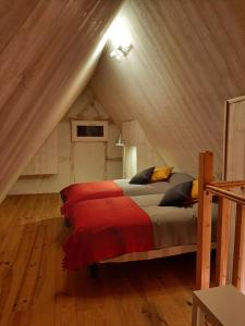ein Schlafzimmer mit einem Bett im Dachgeschoss in der Unterkunft Les Epicuriens du Rempart in Eguisheim