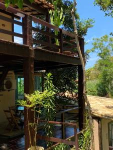 a tree house with a deck and a plant at Recanto da Ferradura in Búzios