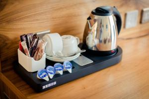 a tray with a tea kettle on a counter at Glashaus Hotel in Tallaght