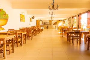 a dining room with wooden tables and chairs at Pouso Tiradentes in Tiradentes