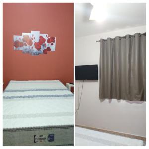 a bedroom with a bed and a curtain at 100 mts Praia Ar Condicionado Wi-Fi 600 Roupa Cama Toalha 24 hs in Santos