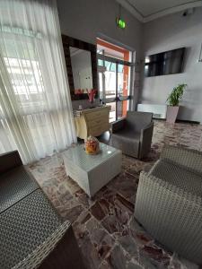 a living room with two chairs and a table at Hotel Venere in Rimini