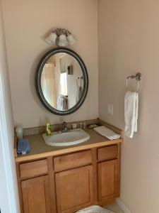 a bathroom with a sink and a mirror at The Adamina in Fairbanks