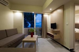 a living room with a couch and a television at Seafalios in Kalamaki Chanion