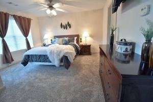 a bedroom with a bed and a ceiling fan at Cozy Renovated Winder Townhouse in Winder