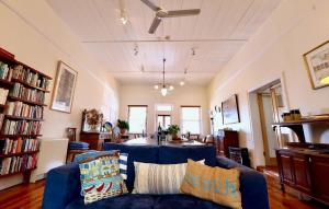 a living room with a blue couch and a table at Grey Masts, Robe in Robe