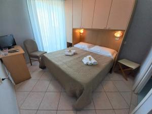 Tempat tidur dalam kamar di Hotel Venere