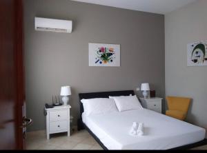 Katil atau katil-katil dalam bilik di Colonna Rooms & apartment