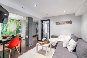 a living room with a couch and a table at NB Urban Luxury Suites in Toronto