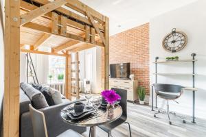 a living room with a table and a couch at NB Urban Luxury Suites in Toronto