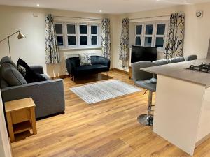 a living room with a couch and a table at The Annex at Pantglas Farm in Pontyclun