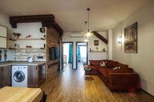 a living room with a couch and a kitchen at A lovely 2-bedroom apartment in central Tbilisi in Tbilisi City