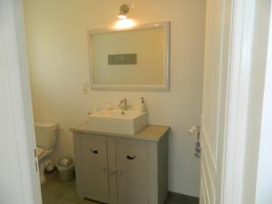a bathroom with a sink and a mirror at Chambre d'hôtes Larosa in Moulis-en-Médoc +4 photos