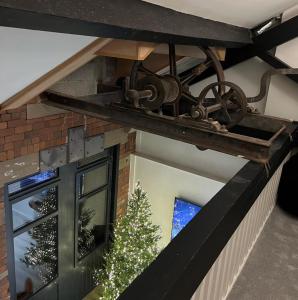 a metal beam on the ceiling of a house with a window at EXCLUSIVE and MODERN - Bradford City Centre- 85" Cinema TV in Bradford