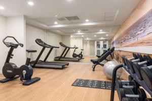 a gym with treadmills and elliptical machines at NH Atlantic Den Haag in The Hague