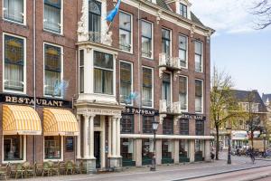 a large brick building on a city street at NH Centre Utrecht Hotel in Utrecht